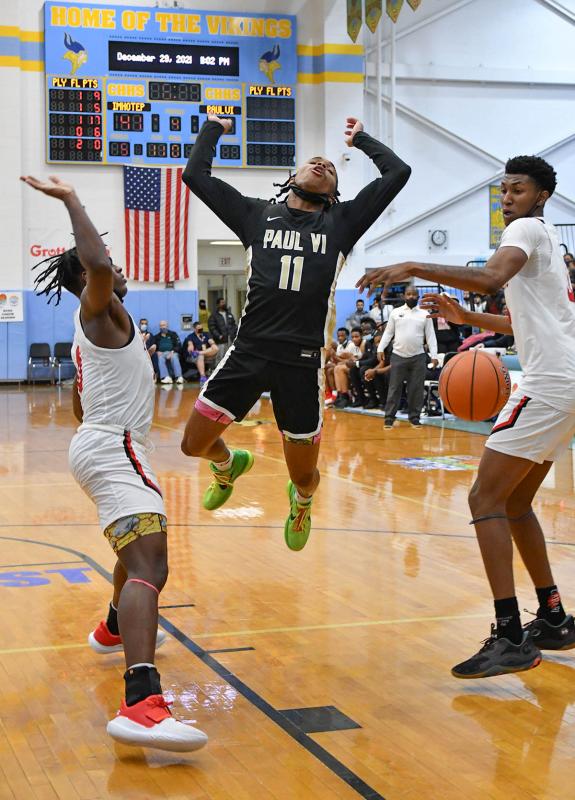 Imhotep’s Justin Edward, right, strips the ball from Paul VI guard Dug McDaniel.