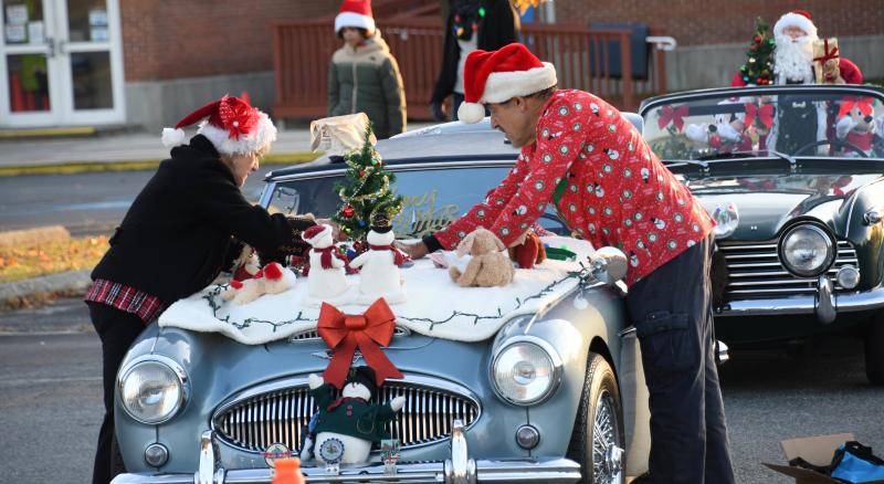 Pat and Mike Tyler add the finishing Christmas decoration touches to their classic 1962 Austin Healy 3000. Tyler is founder of the popular British Motorcar Show in Lewes. The couple added to their awards with a first-place trophy in the classic car division.