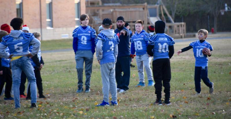 What else do Cape Vikings Pop Warner players do when waiting for the start of a parade? They play some touch football.