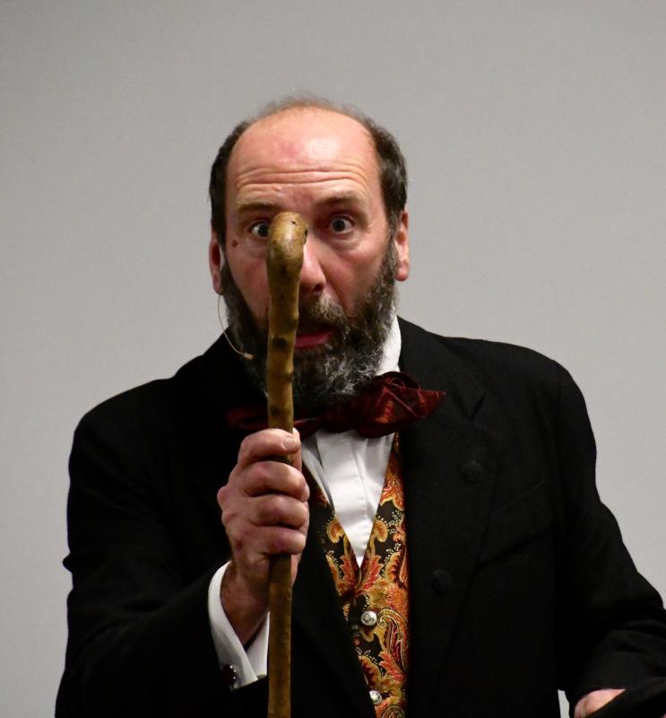 Gerald Dickens, as Ebenezer Scrooge, thinks he sees his departed partner Jacob Marley on his front-door knocker.