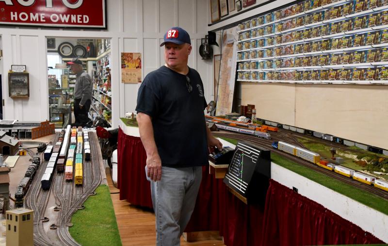 Train master Kevin Brown uses an upgraded control panel to operate three trains with dozens of cars in the layout.