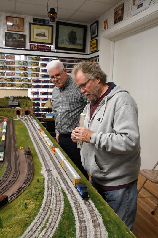 Volunteers Chris Black, yard master, in back, and Ronnie Gillespie helped construct the large model train layout.