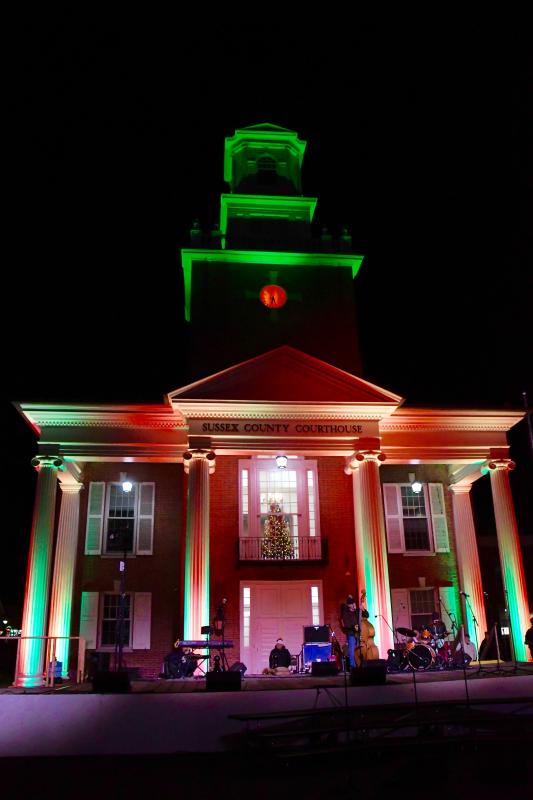 The Sussex County Courthouse, the backdrop to Caroling on The Circle, is bathed in the lights of the holiday.