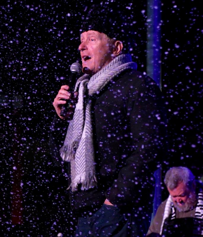 Ed Shockley seems lost in a snowstorm as he sings “I’m Dreaming of a White Christmas.” The snow is courtesy of Mid-South Audio.