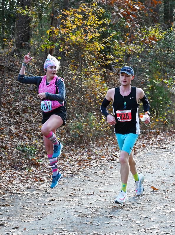 Half-marathon runner Megan Wilkinson leaps out of the way of marathon leader and eventual winner Tyler Muse. NICK ROTH PHOTO