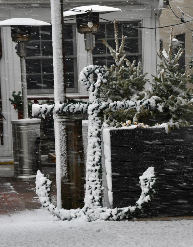 The wet snow is clinging to everything, including the anchor in front of Striper Bites restaurant in downtown Lewes. RON MACARTHUR PHOTO