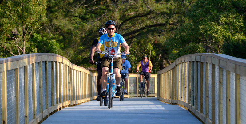 In June 2014, former Gov. Jack Markell is the first to officially ride on the Gordons Pond Trail boardwalk. The trail is a link between Cape Henlopen State Park and Rehoboth Beach.