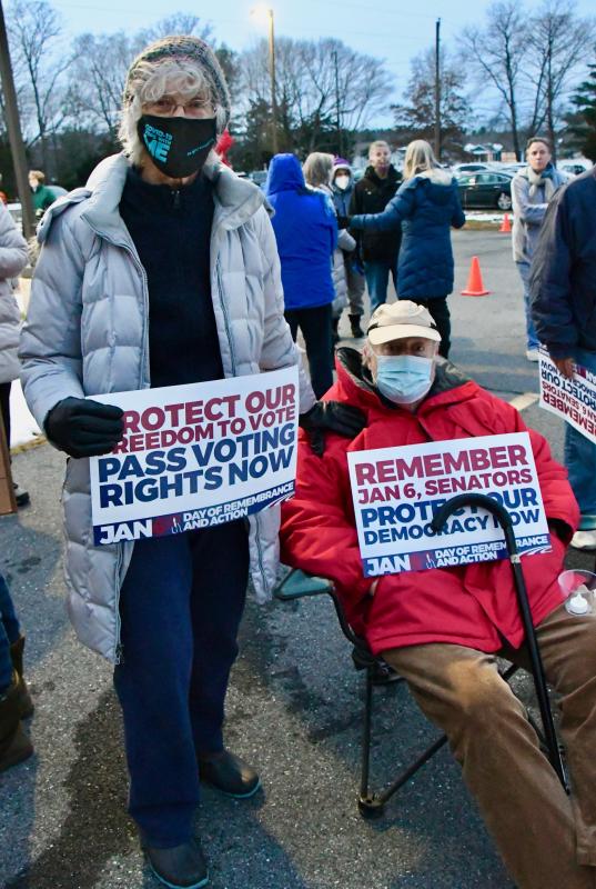 Pat and Jon Bartels of Lewes are among the more than 200 people attending a vigil marking the anniversary of the Jan. 6, 2021 attack on the U.S. Capitol.