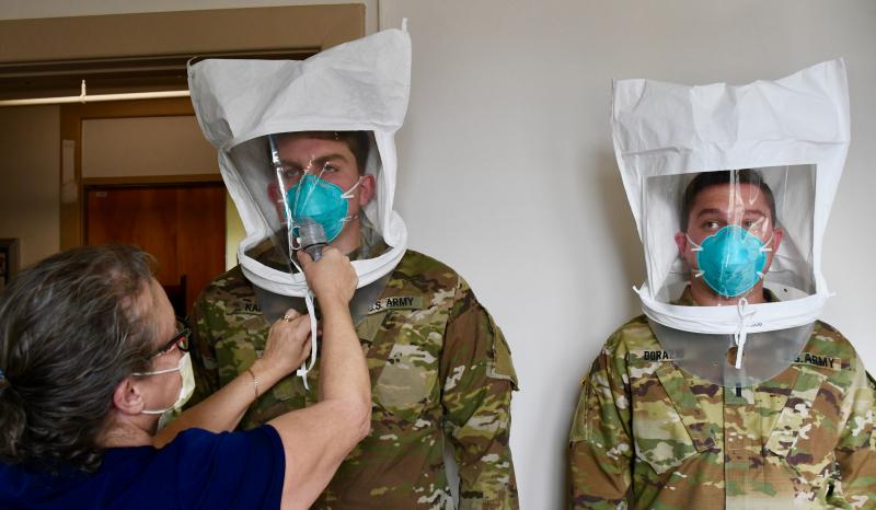 Beebe Healthcare nurse Charlotte Werner begins a fit test to ensure that N95 masks being worn by Delaware National Guard Specialist Dustin Kamin, left, and Lt. Matthew Dorazio fit tightly. Guard members are being assigned to hospitals throughout the state to assist with the recent surge in COVID-19 cases. RON MACARTHUR PHOTOS