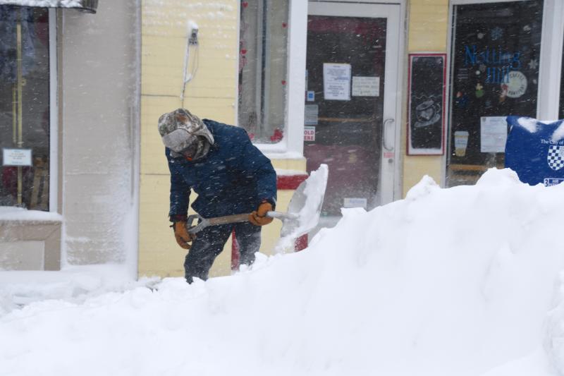 John Downing says you have to pace yourself when shoveling this much snow. He is piling up snow from the sidewalk on Second Street in downtown Lewes. RON MACARTHUR PHOTO