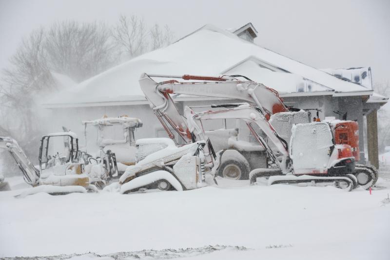 No work today. Heavy machinery at a work site along Savannah Road in Lewes is plastered with snow. RON MACARTHUR PHOTO