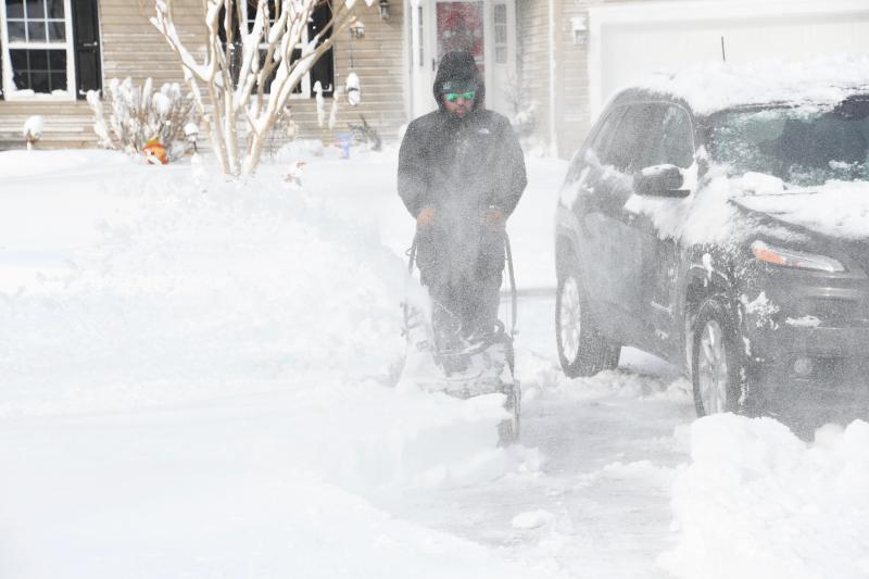 Armed with a snow blower, Mike Curry helps his neighbors in Covey Creek in Lewes. RON MACARTHUR PHOTO