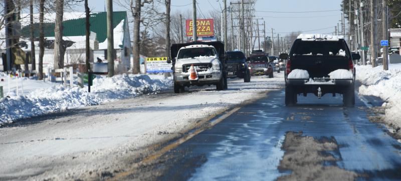 Only one side of Long Neck Road is free of snow. Lots of sun Jan. 30 helped the melt some more snow. RON MACARTHUR PHOTO