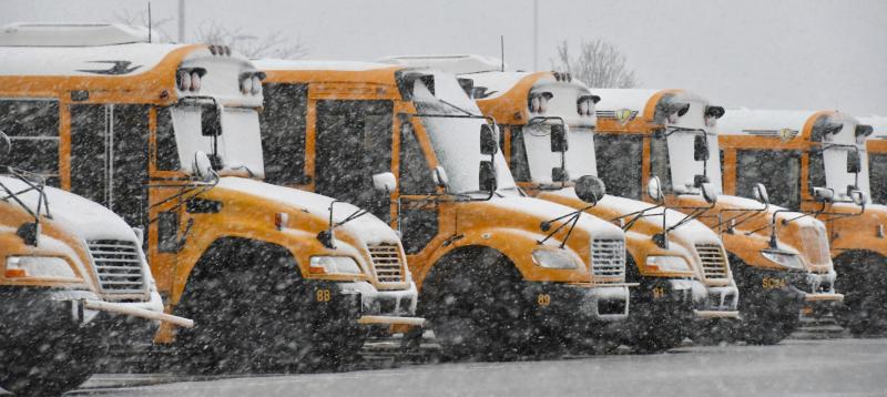 Buses are parked with no school throughout the region due to Monday’s snowstorm. RON MACARTHUR PHOTO