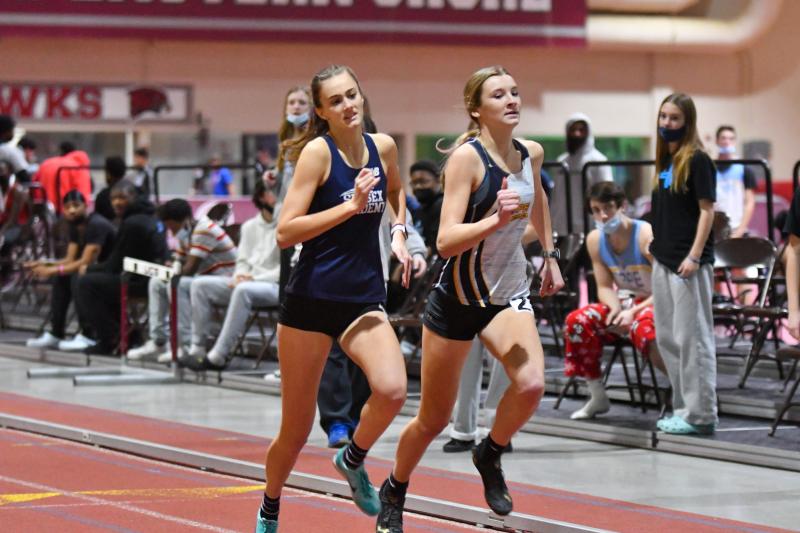 Lily Manlove of Sussex Academy (1:06.20) and Grace Wiggins of Cape (1:06.18) battle in the 400 meters.