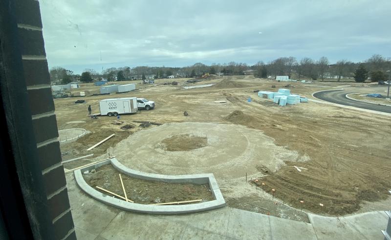 A playground will occupy the space directly behind the school, with athletic fields and walking trails to be constructed as part of the middle school project in the background.