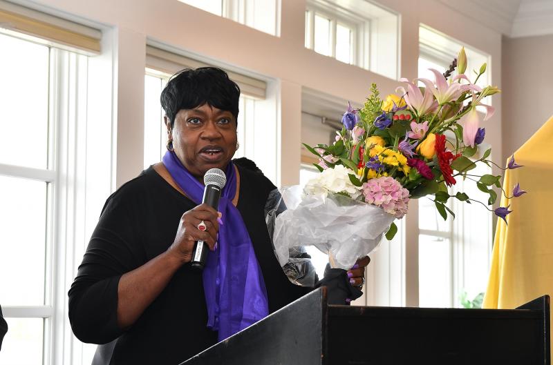 Bernice Edwards of the Community Celebration Committee presents Ardeth Edwards with a bouquet of flowers.