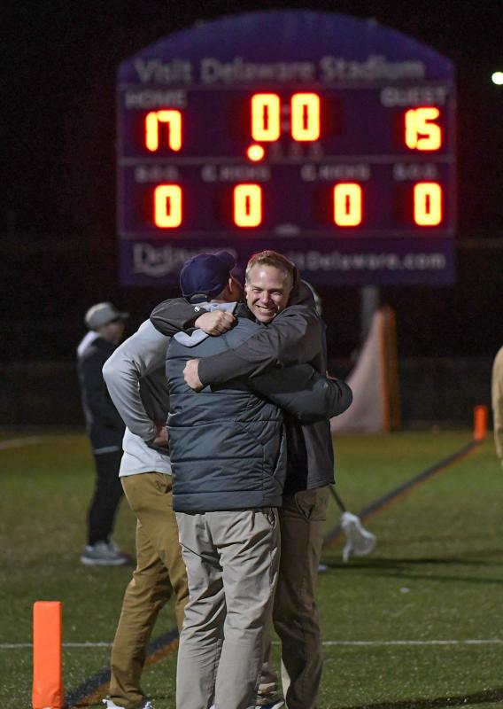 Coaches Sean Tischler and Franc Cook congratulate each other after defeating No. 7 Monroe College 17-15.