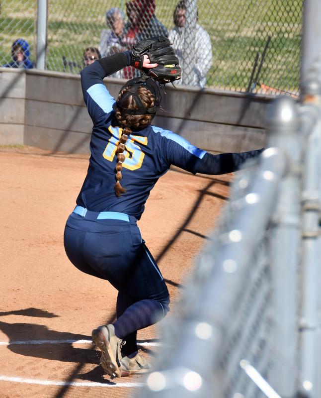 Freshman Alivia Heers feels for the fence and makes a catch on a Dover foul ball.