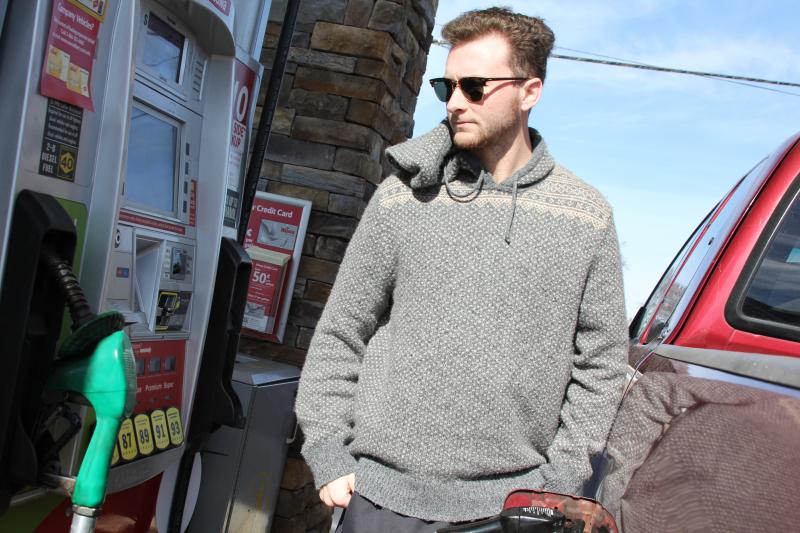 Brendan Kane watches the dollars add up as he fills his tank March 8 near Rehoboth. MELISSA STEELE PHOTO