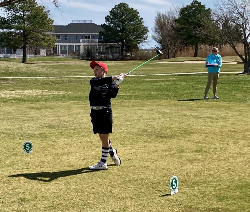 Christian Bennett of Wilmington watches his opening drive on the first tee during the March 20 U.S. Kids local tour event held at Rehoboth Beach Country Club. Tournament volunteer Julie Rollins observes from a safe spot behind him. The tournament was the second in the inaugural six-event series helping to promote junior golf in southern Delaware. Nearly three dozen players from several states came to play. FRITZ SCHRANCK PHOTOS