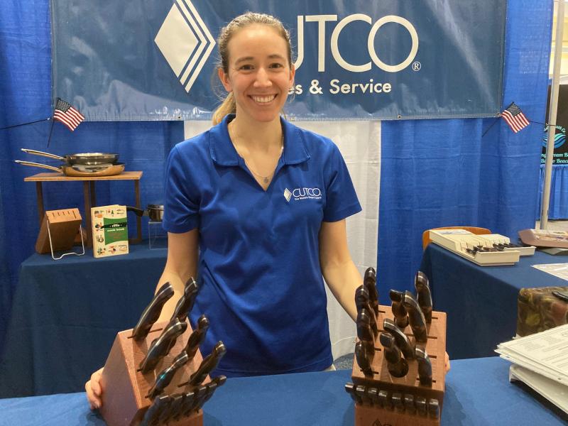 Cutco service representative Kelly Stottlemyer shows off the company’s collection of kitchen cutlery.