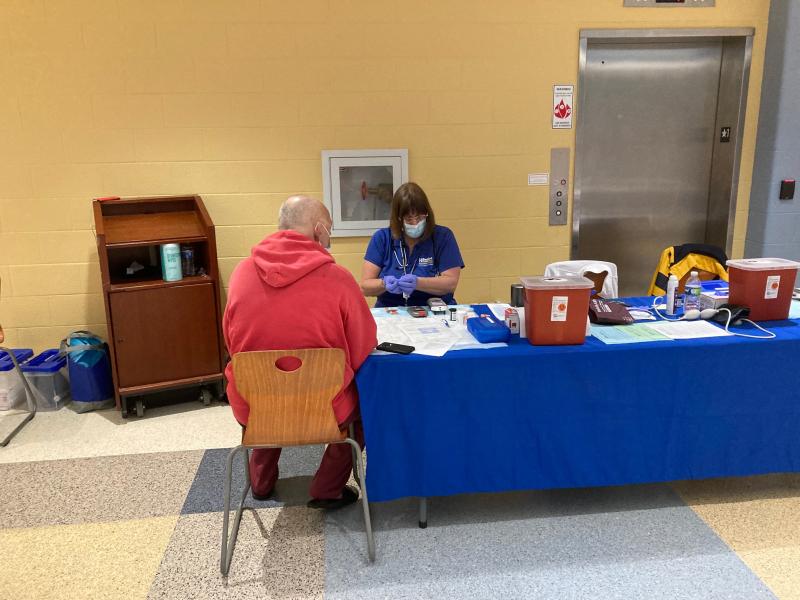 Beebe Healthcare nurse Sue Peet performs a health screening.