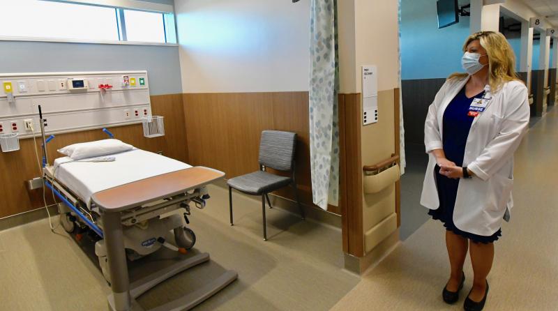 Regina Newell, RN, explains how patients and staff will utilize one of the 18 pre- and post-operative rooms.
