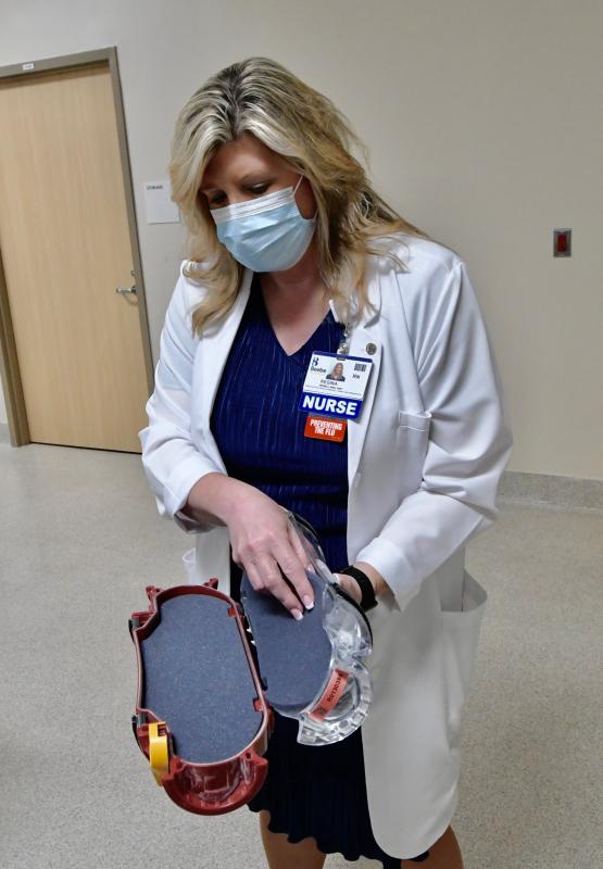 Regina Newell, RN, explains how blood samples will be shipped via an underground tube between the adjacent Rehoboth Health Campus and Tunnell Cancer Center, and the new consolidated laboratory.