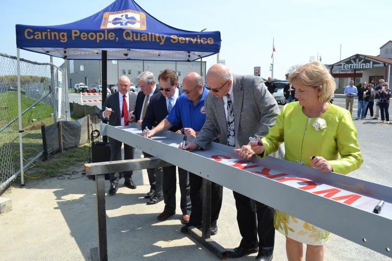 Members of Sussex County Council, along with Georgetown Mayor Bill West sign the final beam to be placed atop the expanded Emergency Operations Center. Taking part are (l-r) Council Vice President Doug Hudson, Councilman John Rieley, Councilman Mark Schaeffer, Mayor West, Council President Michael Vincent and Councilwoman Cynthia Green. SUSSEX COUNTY PHOTO