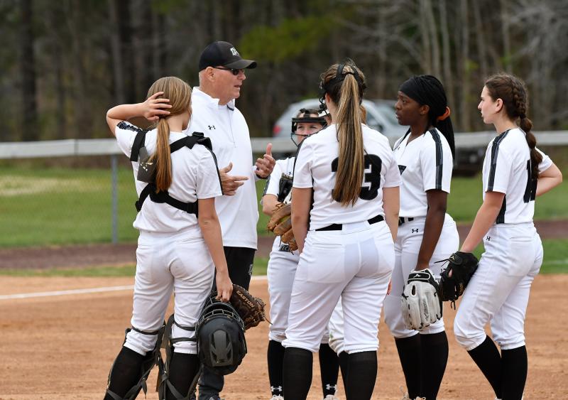 Tech manager John Marvel speaks to his team as he makes a pitching change.