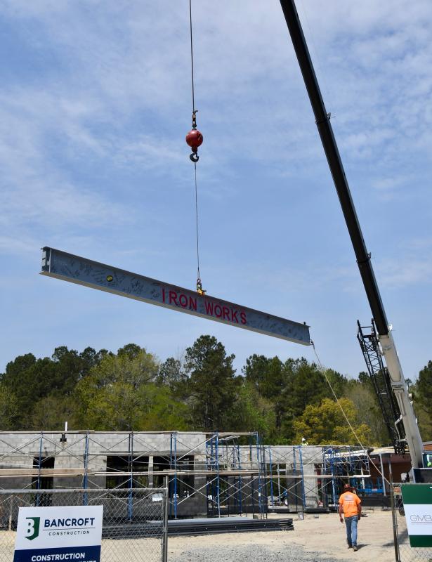 The Iron Works steel beam is lifted by a crane at the construction site in the Delaware Coastal Airport complex.