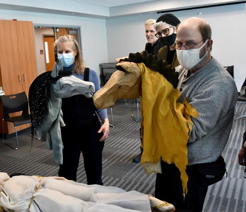 Under the direction of program leaders David Logan Rankin and Suzanne Savoy, in the back, help Margie Pulkingham and Bill Burford with horse puppets.