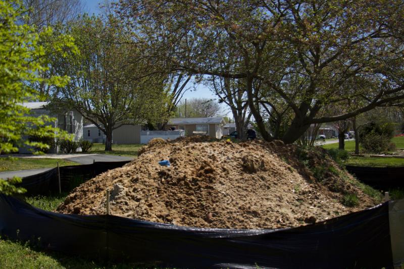 Soil taken out of the failed septic tanks sits on the property. Testing done by residents revealed contamination.