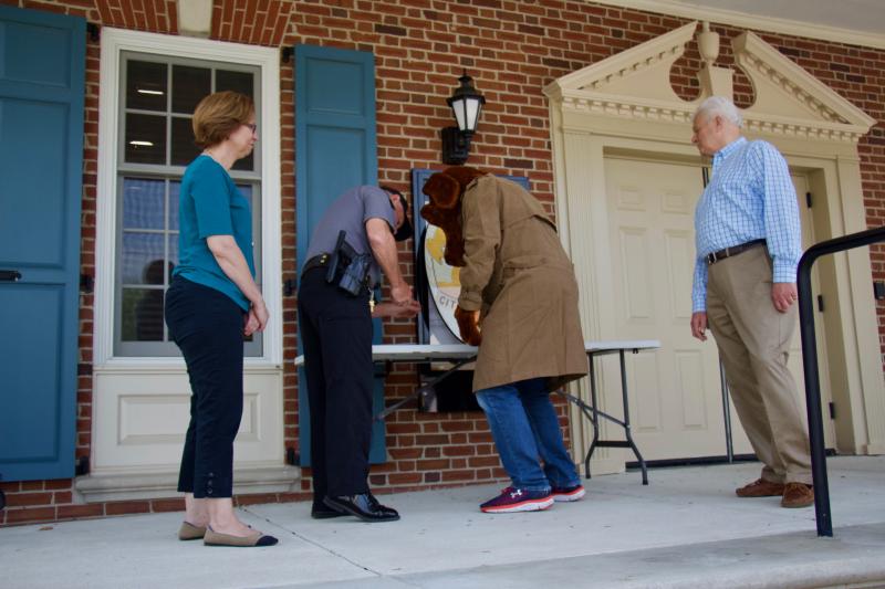 McGruff paws his signature making the partnership made possible by the Lewes Police Foundation a reality.