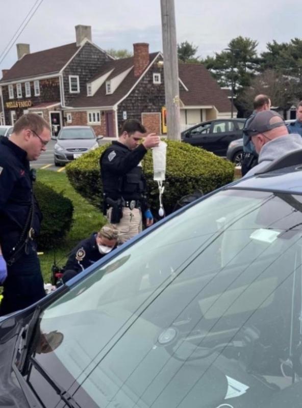 Dewey Beach Police Officer Jack Kane, holding IV bag in center, rescued seven people and a dog from the house fire on Bayard Avenue. On his way home after his shift, he was one of the first responders to arrrive on the scene of an incident where a person was in cardiac arrest near the Movies at Midway. SUBMITTED PHOTO