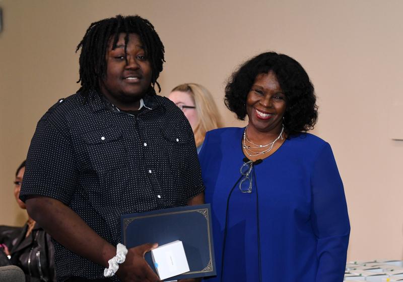 Pathways to Success founder and Executive Director Fay Blake presents a diploma and cord to Lawrence Turner of Seaford High.