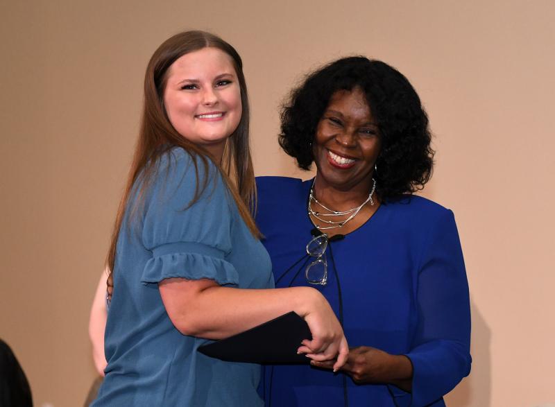 Morgan Peterson from Sussex Tech receives her cord and diploma from Pathways to Success founder and Executive Director Fay Blake.
