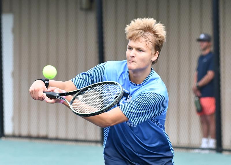 Cape sophomore Oliver Townsend pops a backhand volley in his first-round win over Elliott Miller from Polytech 7-6 (7-1), 6-3.