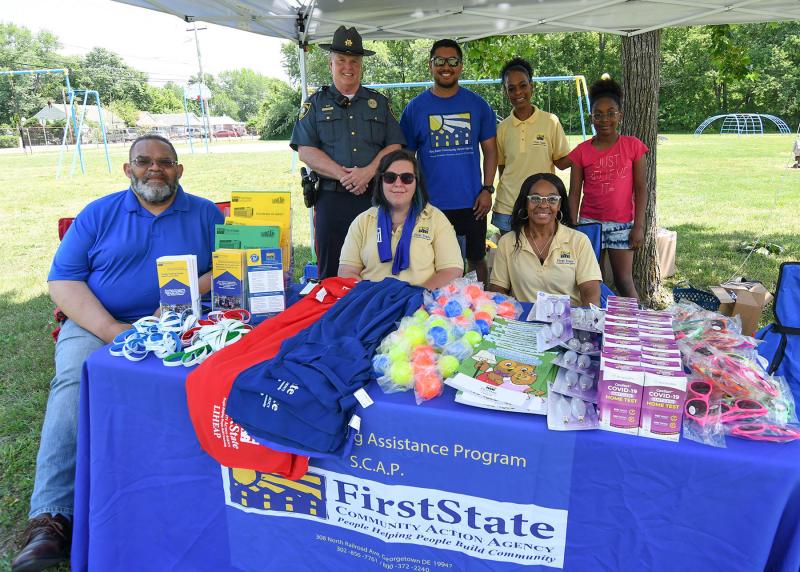 Members of First State Community Action Agency give out information on services they offer, COVID tests, energy-saving tips, rental assistance, utility assistance and food pantry, among others. Shown are in back are (l-r) Georgetown Police Chief Ralph Holm, Brentdy Chavez, Sandi Hagens-Morris and Aree Youmans, 8. Sitting are Bruce Wright, Jaime Sayler and Martin Duffy.
