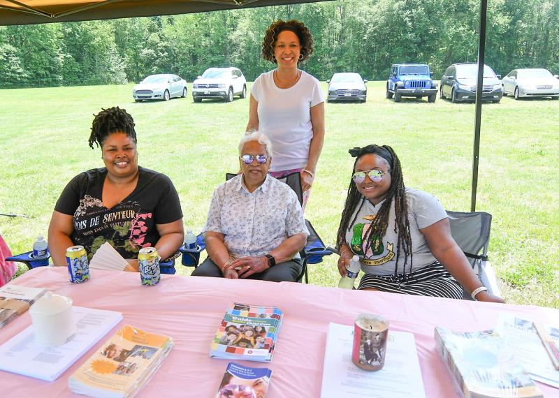 Members of the Alpha Kappa Alpha sorority provide information. Shown in back is Shorel Clark. In front are (l-r) Yvonne Lomax, Mary C. Lomax and Akiliah Church.