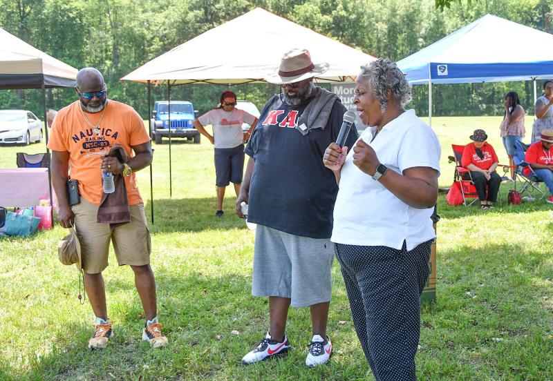 Pastor Tambara Stewart of the Restoration Worship Center opens the event in prayer.