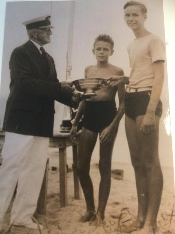 In a photo from his boyhood, Rowland, center, and Frank Carter Sr. are shown receiving a trophy for winning a race. FAMILY PHOTO