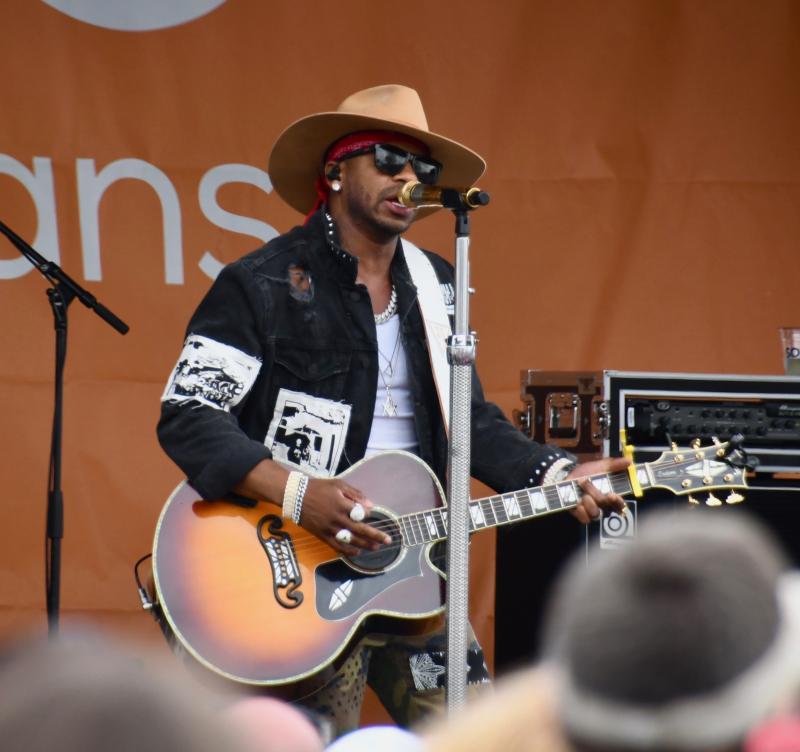 Jimmie Allen, who was born and raised in Milton, performs with his guitar at Dover Motor Speedway on May 1.