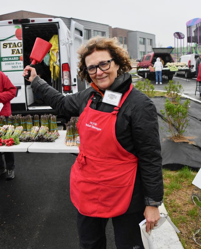Director Helaine Harris rings the bell to officially open the Lewes market at 8 a.m., May 7, to start another season. Even a nor’easter did not postpone the event.