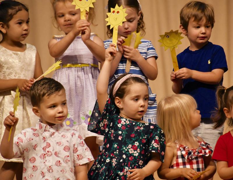 Duckling Class students sing “You Are My Sunshine” during the end-of-year spring program. They are (l-r) Camila Morales, Lily Schrock, Cassie Danz, and William Dashiell in back; in front are Nathan Franco, Luna Franco and Madeline Eisenstein.