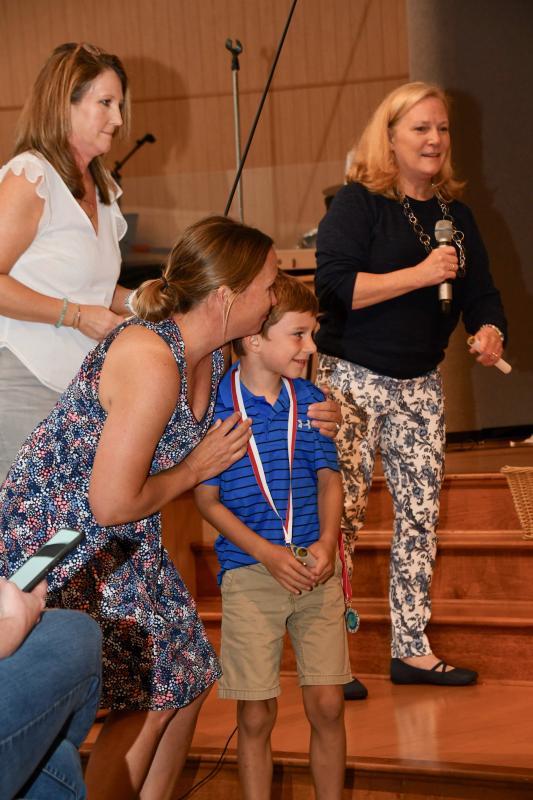 Pelican Class member Webb Ciavarra receives graduation congratulations from teachers (l-r) Trish McDaniel and Carrie Dare, and director Betsy Plowman.