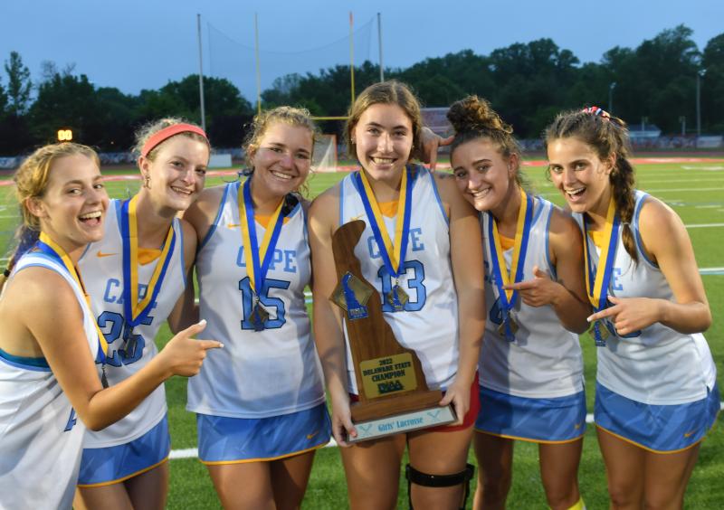 Cape seniors Sierra Manifold, Maren Buckaloo, Kelly Bragg, Ella Rishko and Molly Mendes give the trophy to injured sophomore Carrie Clausius.