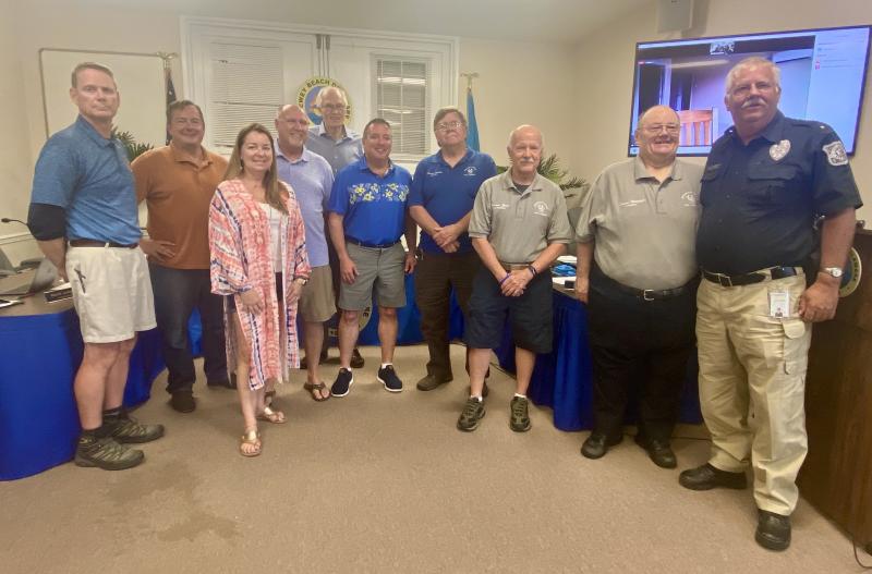 Gathered at the Dewey Beach Lifesaving Station May 20 are (l-r) Town Manager Bill Zolper, Commissioner David Jasinski, Commissioner Elisabeth Gibbings, Commissioner Paul Bauer, Commissioner Gary Persinger, Mayor Bill Stevens, Rehoboth Beach Volunteer Fire Company Fire Chief Chuck Snyder, Rehoboth Beach Volunteer Fire Company Vice President Warren Jones, Rehoboth Beach Volunteer Fire Company President Danny Mitchell, and Dewey Beach Police Chief Sam Mackert. ELLEN DRISCOLL PHOTO