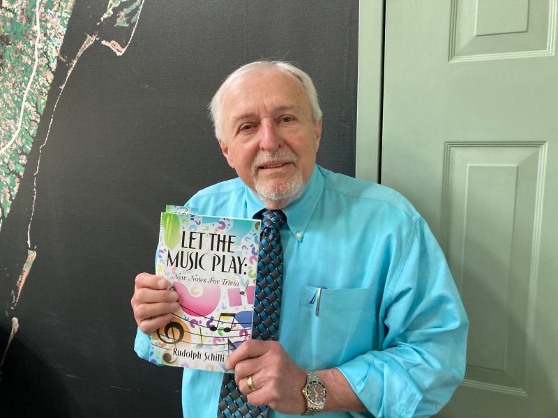 Dr. Rudolph Schilli recently published his first book, “Let The Music Play: New Notes For Trivia,” which provides questions and musical clues to allow people to engage deeper with trivia games. A gastroenterologist at Beebe Healthcare, Schilli has been practicing medicine for nearly 50 years. RYAN MAVITY PHOTO